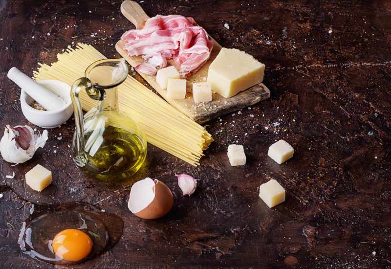 Traidtional Italian Pasta Carbonara Ingredients: Bacon, Spaghetti, Parmesan and pecorino cheese, egg, garlic and olive oil.